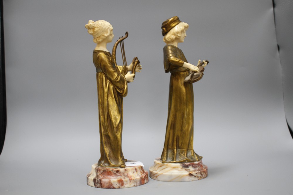 A pair of Alphonse Gori ivory and ormolu figures of medieval musicians, girl playing an Irish harp, the other plucking a violin, on mar
